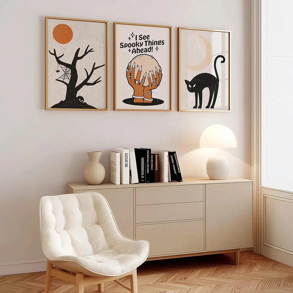 Modern interior with a sideboard, chair, and wall art featuring a tree, fortune-teller's hands with magical orb, and cat.