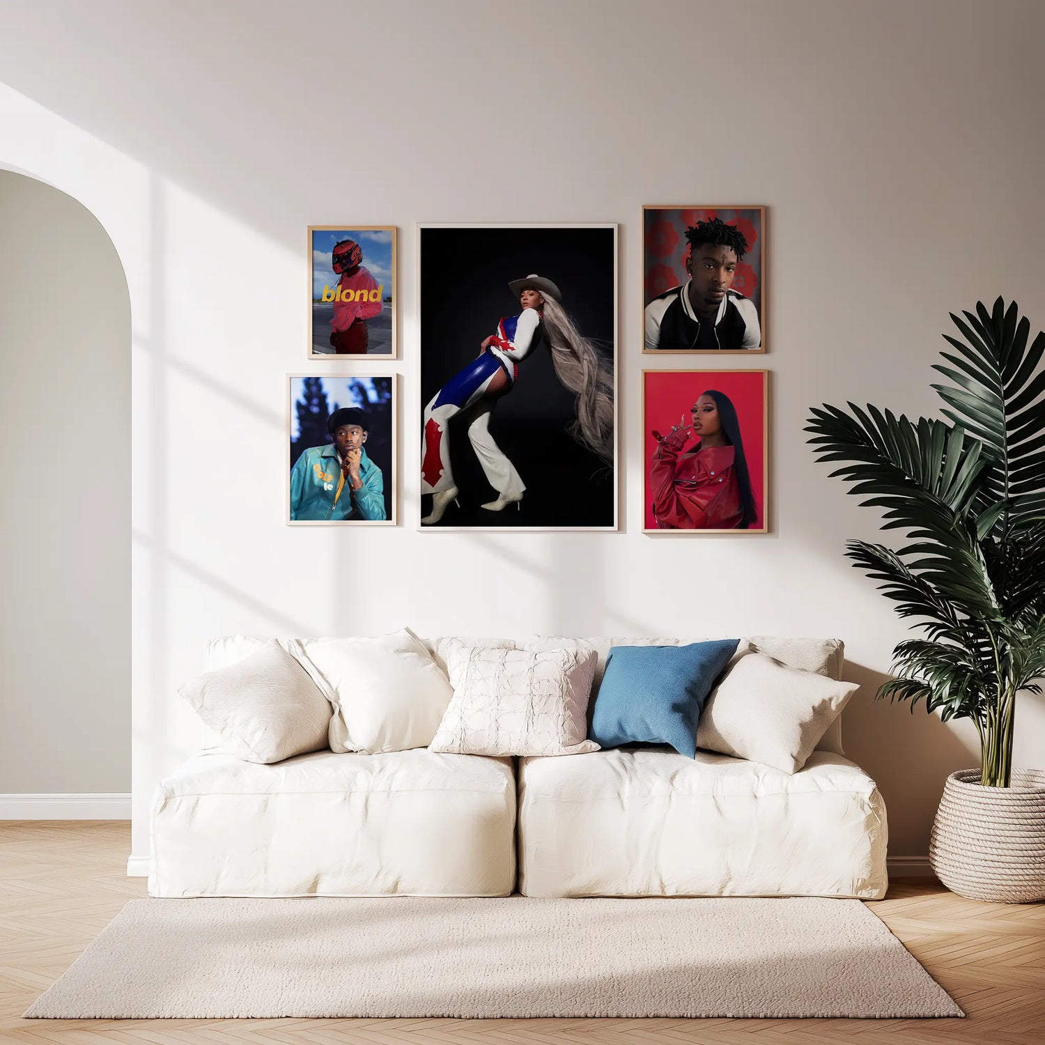 Living room with a white sofa, decorative pillows, and framed artwork on the wall.