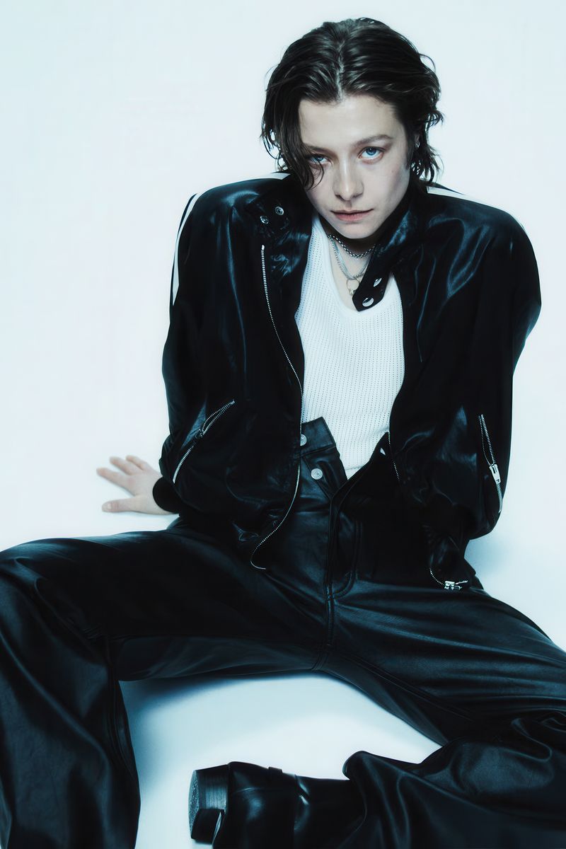 Emma D Arcy in Black Leather Suit Poster | Seated Wall Art Print - Celebrities Poster